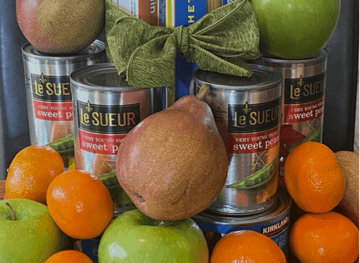 Canned food and fresh fruit arranged as a centerpiece
